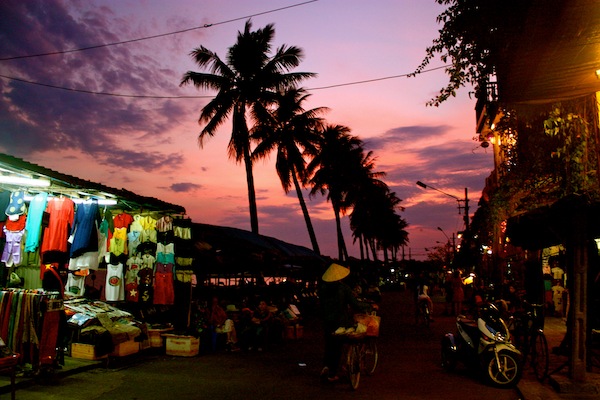 Palm trees and street stall at sunset in Hoi An, Vietnam Palm trees and street stall at sunset in Hoi An, Vietnam