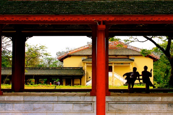 Silhouette of two men on temple grounds at Hue Imperial City Citadel, Vietnam Silhouette of two men on temple grounds at Hue Imperial City Citadel, Vietnam
