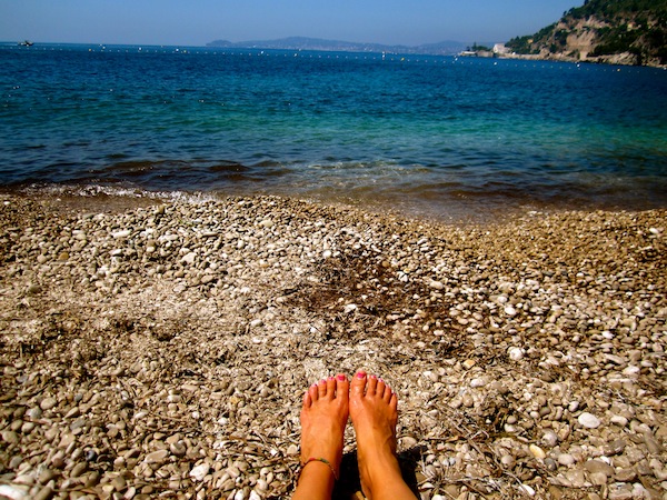 Bare feet at Cap D'Ail Beach in the French Riviera, France Bare feet at Cap D'Ail Beach in the French Riviera, France
